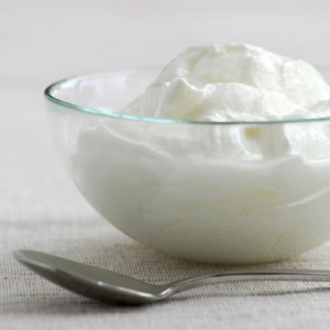 Fresh yogurt served in a clear glass bowl