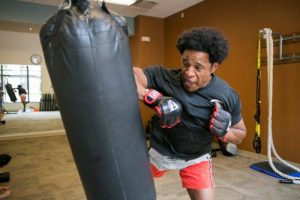 Charles Gibson hitting punching bag